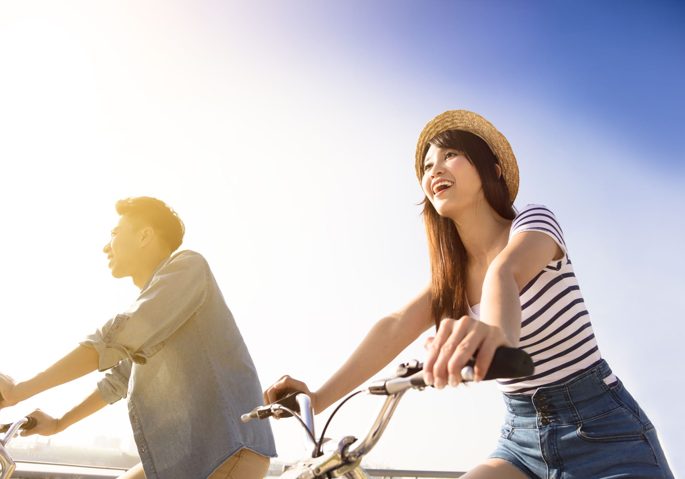 50480646 - happy young couple going for bicycle ride on a sunny day 50480646 - happy young couple going for bicycle ride on a sunny day